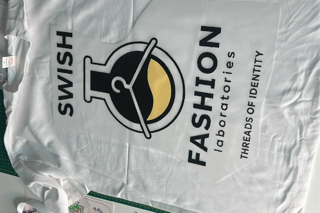 Custom vinyl printed t-shirt in Midrand — bold logo design on dark garment by Pixelsinframe