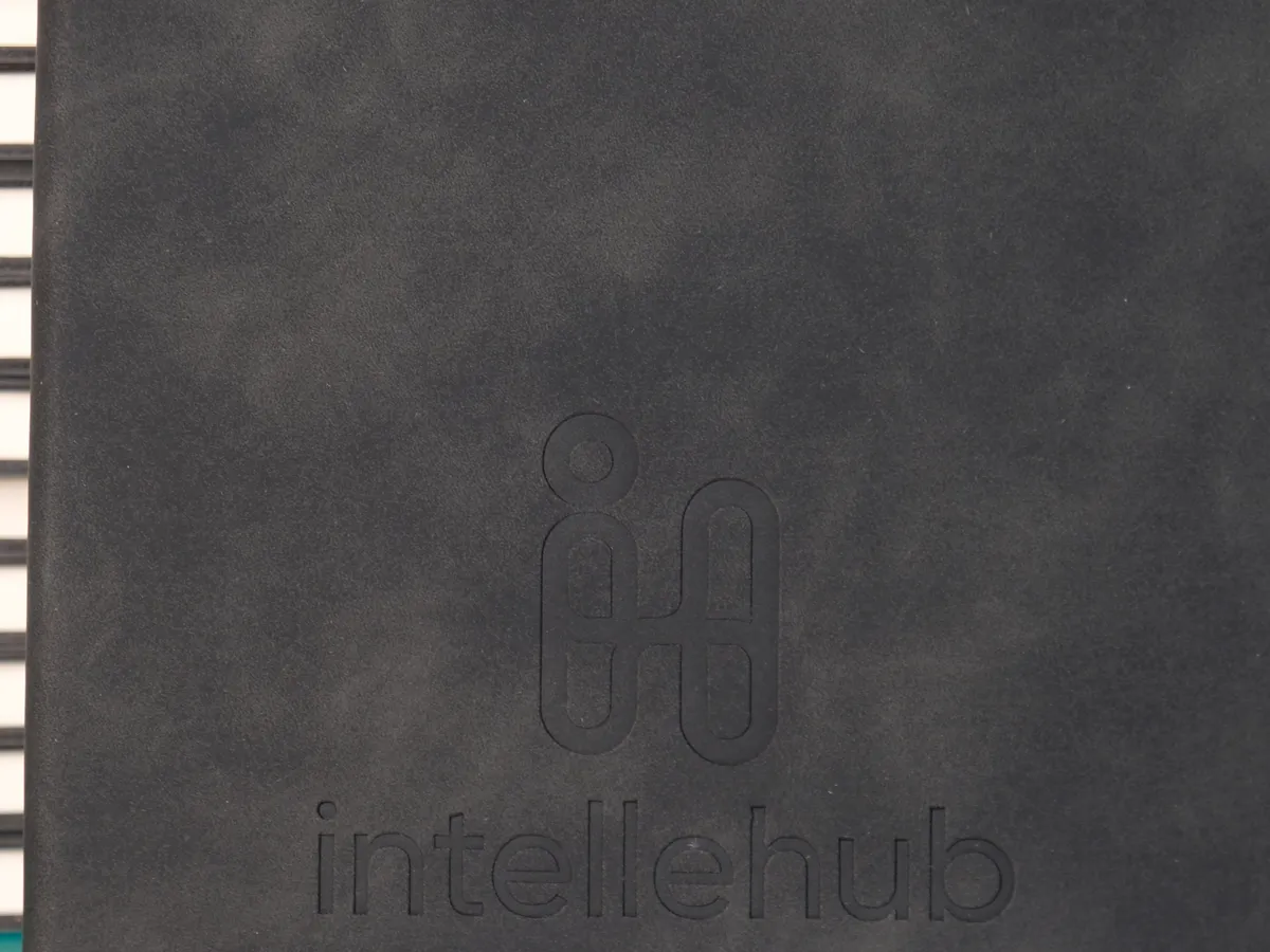 Debossed logo on a grey corporate notebook